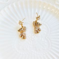 Show off your cute and playful side with these Star Teddy Bear Drop Earrings. Each earring features an adorable bear reaching for a star, symbolizing your own aspirations and dreams. Perfect for adding a touch of whimsy to any outfit. Let these earrings inspire you to reach for the stars. Dimensions: 1.2cm*2.8cm Materials: 14k-Gold plated brass, rhinestone, 925 silver needles Reach For The Stars, Reaching For The Stars, Your Cute, Christmas Shopping, Free Gifts, 925 Silver, Teddy Bear, Drop Earrings, Stars