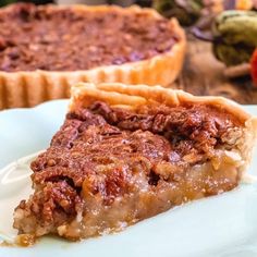 a piece of pecan pie on a plate with another slice in the back ground