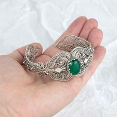 "A  vintage look and delicate cuff bracelet made with 925 sterling silver and a beautiful green gemstone. 925 Sterling Silver Women Cuff Boho Bracelet with Green Moss Agate Gemstone is the perfect gift for your wife on your anniversary or your best friend on her birthday. The intricately detailed design is handcrafted with lace and detailed filigree work. The bracelet is adjustable from 7\" to 8.50\" to fit most wrists and comes with a velvet pouch, a polish cloth, and a luxurious gift box.              Moss Green Agate Gemstone is natural and is size 12 X 16 mm. Carat Weight is 6ct. It is adjustable from 7\" to 8.50\" to fit the wrist. Comes with a velvet pouch, silver polish cloth and a luxurious gift box.                            Filigree is made of delicate metal strands that have be Ethereal Jewelry, Gemstone Cuff Bracelet, Green Moss Agate, Fancy Jewellery, Boho Bracelet, Citrine Stone, Detailed Design, Green Agate, Velvet Pouch