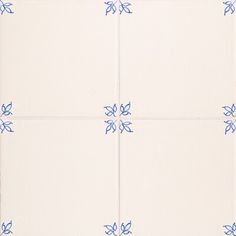 four white tiles with blue flower designs on them