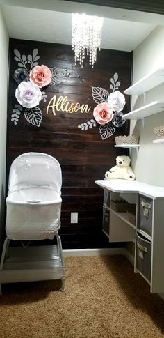 a baby's room with a crib and chandelier hanging from the ceiling