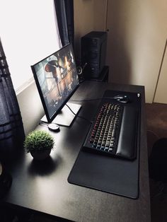 a computer desk with a keyboard, mouse and monitor sitting on it's side