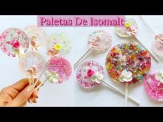 the lollipops are decorated with flowers and sprinkles