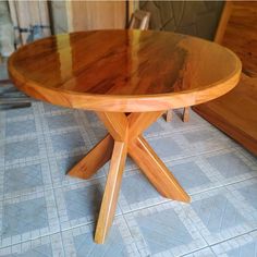 a wooden table sitting on top of a tiled floor