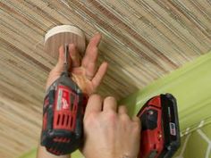 a person is working on the ceiling with two drillers and a cordless screwdriver