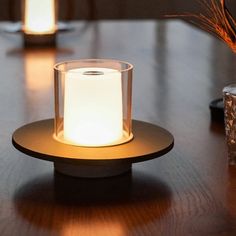 a lit candle sitting on top of a wooden table