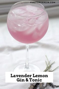 lavender lemon gin and tonic cocktail in a coupe glass with rosemary sprigs on the side