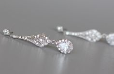 "Elegant 'modern-vintage' Bridal earrings have been designed in a delicate open-work style studded with cubic zirconium crystals with a crystal teardrop, to add a gorgeous delicate sparkle to your wedding day. Set in tarnish resistant 18K Rhodium (White Gold Plate) with high quality cubic zirconium crystals for heirloom quality. Allergy free. L = 1 3/4\" (4.5 cm) Our model wears our store sample ear post. ★Shopping for your bridal party? Contact us for special pricing. Please read our shop polic Wedding Crystal Diamond Earrings (pierced), Exquisite Pierced Bridal Earrings, Wedding Crystal Diamond Earrings Pierced, Wedding Diamond Crystal Earrings Pierced, Pierced Diamond Crystal Earrings For Wedding, Vintage White Diamond Earrings For Wedding, Vintage Sterling Silver Chandelier Earrings For Wedding, Elegant Diamond White Pierced Crystal Earrings, Ornate Diamond-accent Earrings For Wedding