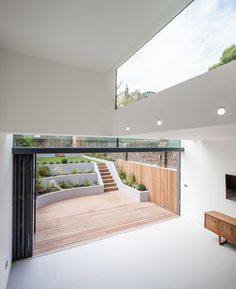 an open living room with stairs leading up to the roof