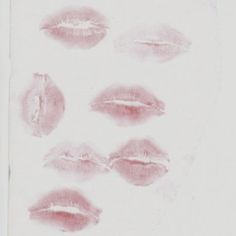 six different types of lipstick on a white sheet with red ink in the shape of lips