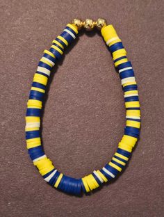 Made by my 10 y/o daughter. Minion colors! Great for kids! Good for all occasions! Gender Neutral. Purple Bracelet Clay Beads, Yellow And Purple Clay Bead Bracelet, Purple And Yellow Beaded Bracelet, Pink Purple And Blue Clay Bead Bracelets, Purple Clay Bead Bracelet, White Clay Bead Bracelet, Blue Clay, Clay Bead Bracelet, String Bracelets