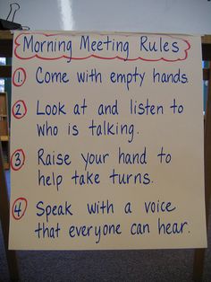 a sign that has been placed in front of a wooden table with writing on it