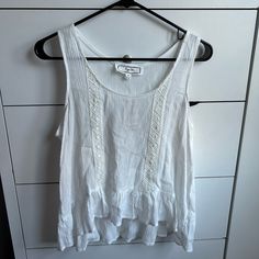 Nwt Hippie Rose (From Macy’s) Ivory Colored Tanktop! Flowy Style And Very Loose Material. Has 2 Parallel Stripes Of Lace As A Design On The Front Side. Includes Ruffles On The Bottom Part Of The Top. Never Worn Before And In Perfect Condition. Size Medium. White Floral Print Hippie Top, White Bohemian Spaghetti Strap Tank Top, Beige Bohemian Cotton Tank Top, Cheap White Hippie T-shirt, Bohemian Stretch V-neck Tank Top, Work Tops, Beautiful Blouses, Ivory Color, Ruffles