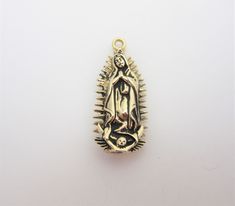 "-14kt yellow gold -Hand cast, polished and antiqued -3-D -Perfect for charm bracelets and pendant necklaces -Detailed, intricate design featuring New Mexico landmarks -14kt jump ring included on most charms (not in photos) -Made in New Mexico, USA -Our lady of Guadalupe is widely worshiped in Mexico and New Mexico. The Virgin of Guadalupe holds special significance in the history and culture of New Mexico such as at The Santuario de Guadalupe, the oldest church in the United States honoring the 14k Gold Spiritual Miraculous Medal Jewelry And Charms, 14k Gold Spiritual Miraculous Medal Jewelry, Traditional Gold Jewelry For Commemoration, Gold Antique Finish Jewelry For Commemoration, Antique Finish Gold Jewelry For Commemoration, Gold Spiritual Charms And Jewelry, Gold Spiritual Jewelry And Charms For Wedding, Gold Jewelry With Antique Finish For Collectors, Spiritual Yellow Gold Our Lady Of Guadalupe Jewelry