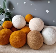 several different colored balls sitting on the floor in front of a wall with white stars