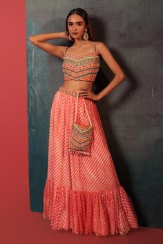 Peach padded blouse with thread, beads embroidery and Kathiawadi work. Paired leheriya couching skirt and embroidered potli.
Components: 3
Pattern: Embroidered
Neckline: Sweetheart
Sleeve Type: Sleeveless
Fabric: Pure Georgette, Silk
Color: Peach
Other Details: 
Attached lining
Embroidered belt
Length: 
Blouse: 14 inches
Lehenga: 42 inches
Occasion: Wedding - Aza Fashions Thread Beads, Beads Embroidery, Padded Blouse, Embroidered Belt, Belt Length, Dresses Indian, Embroidered Neckline, Designer Dresses Indian, Set For Women