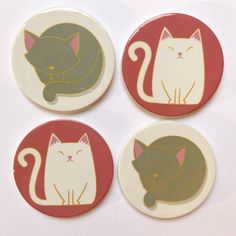 four coasters with cats on them sitting next to each other