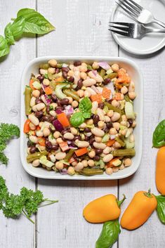 a white plate topped with beans and vegetables