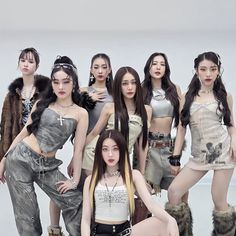 a group of young women standing next to each other in front of a white background