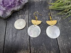 "These lightweight earrings feature 25mm opalescent natural Filipino mirror shell discs dangling from 21mm x 10mm raw brass half-moon or semi-circle charms. The natural shell discs may have some yellow or pinkish inclusions. The ear wires are made of hypoallergenic gold-plated surgical steel, making these safe for sensitive ears. These earrings measure approximately 2 inches from the top of the ear wires to the bottom of the oval charm and are very lightweight, weighing just 0.1 ounce each. Dome Seashell Earrings, Bronze Earrings, Gold Statement Earrings, Lightweight Earrings, Wooden Earrings, Shell Earrings, Brass Jewelry, Light Weight Earrings, Brass Earrings