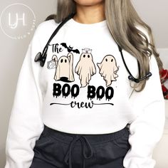 Funny Nurse Sweatshirt or Shirt - The Boo Boo Crew Introducing our hilarious and spooky "The Boo Boo Crew" Halloween shirt, designed especially for all types of nurses! Get ready to spread laughter and Halloween spirit with this delightful shirt featuring retro ghosts holding medical tools. Crafted with high-quality materials, this shirt ensures utmost comfort and durability for long hours at work or festive celebrations. Whether you're a nurse looking for a lighthearted way to showcase your ded Halloween Nurse Tshirt, Halloween Nurse Sweatshirt, Medical Halloween Shirts, Boo Boo Crew Shirts, Medical Shirt Ideas, Costumes For Nurses At Work Halloween, Halloween Crew Neck Top With Graphic Print, Long Sleeve Horror T-shirt With Letter Print, Horror Long Sleeve T-shirt With Letter Print