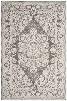 a gray and white rug with an ornate design on the bottom, in front of a white background