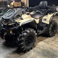 a white and black four - wheeler parked in a garage