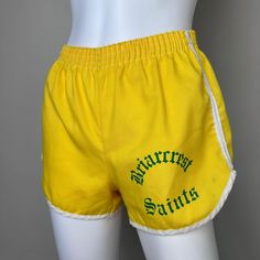 70s Gym shorts from Memphis school Briarcrest. These have an elastic waist.  The fabric does not stretch. Brand - I can't read the brand name Content - I can't really read it but I do see that Cotton is one of the fibers  Size - Labeled Size Small but maybe better for a modern XS so please check all measurements to ensure fit Waist - 9.5" across, stretches to 16" Hips - 19.5" across Rise - 10" Inseam - 2.75" Outseam - 9" Leg Opening - 11.75" across Condition - There are a few marks as pictured Retro Cotton Shorts With Elastic Waistband, Retro Stretch Cotton Shorts, Vintage Cotton Shorts With Elastic Waistband, Retro Cotton Athletic Shorts For Summer, Vintage Athletic Shorts For Summer, Vintage Stretch Short Length Bottoms, Vintage Summer Athletic Shorts, Retro Cotton Athletic Shorts, Brand Me