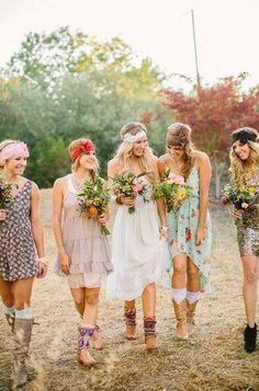 a group of women standing next to each other on top of a grass covered field