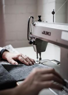 a person using a sewing machine to sew something