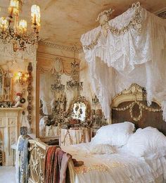 an ornately decorated bedroom with white bedding and chandelier hanging from the ceiling