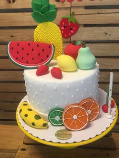 a cake decorated with fruit and decorations on a plate