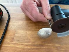 a person using a sanding tool on a piece of wood next to a power drill