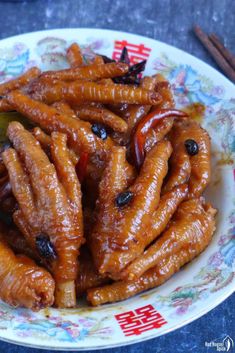 a plate full of cooked carrots on a table