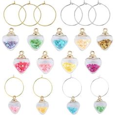 six pairs of earrings with different colors and designs on them, all hanging from gold hoops