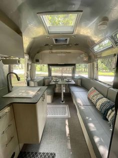 the inside of an rv with couches and kitchenette in it's center