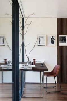 a table with two chairs and pictures on the wall