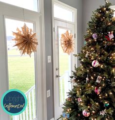 a decorated christmas tree sitting in front of a door with an ornament on it