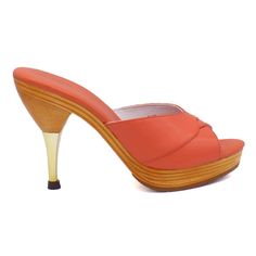 This iconic 1950's style stiletto slide is comfortable and sexy with a padded foot-bed and stable base.  Leather uppers with blond wood platform sole Whole sizes, 5-11 4½" metallic finished stiletto heel with a ⅞" laminated wood platform  Imported Modern Slip-on Heels With Wooden Heel, Fitted High Heel Mules With Deep Heel Cup, Modern Heels With Wooden Heel For Party, Modern High Heels With Rubber Heel Cap, Elegant Open Heel Platform Slippers, Modern High Heel Platform Slippers With Deep Heel Cup, Chic High Heel Clogs With Deep Heel Cup, Formal Mules With Wooden Heel And Almond Toe, Chic Platform Slippers With Sculpted High Heel