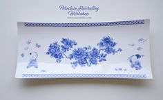 a blue and white plate with flowers on it