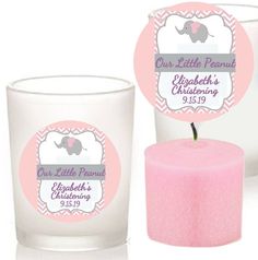 two candles with labels on them sitting next to each other