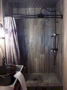 a bathroom with a walk in shower next to a sink