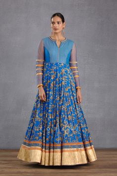 Editor's Note Featuring a persian blue bhagalpuri printed anarkali with short jacket in slub silk Color: Blue, orange Fabric: Slub silk Components: Anarkali and jacket Fit: Fit and flare Occasion: Festive Care: Dry Clean Only About the Designer Torani by Karan Torani stands handcrafted luxury inspired by the myriad tales of Indian mythology. Torani is a potpourri of all things nostalgic that binds you with a memory long forgotten. The label works with and revives timeless Indian textiles and emb Anarkali Jacket, Embroidered Orange, Blue Anarkali, Printed Anarkali, Persian Blue, Indian Textiles, Lace Trims, Jacket For Women, Orange Fabric