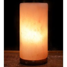 a lit candle sitting on top of a wooden table