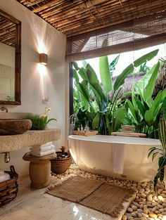 a bath room with a tub a sink and some plants