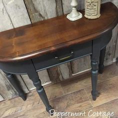 a wooden table with a lamp on top