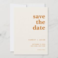 a save the date card on top of a marble surface with gold foil lettering and a white envelope