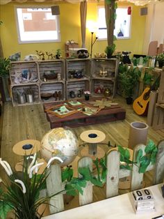 a room filled with lots of furniture and plants on the floor next to each other