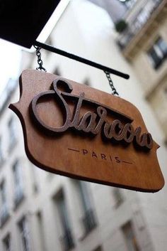 a sign hanging from the side of a building that says,'starwood paris '