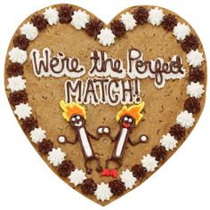 a heart shaped cookie with the words we're the perfect match on it